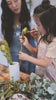 A little girl and her mom arranging flowers